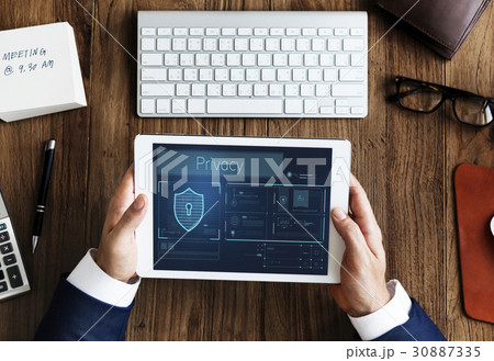 Hands working on digital device network graphic overlay Hands working on digital device network graphic overlay 30887335