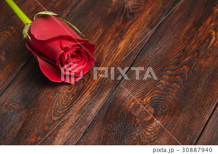 Beautiful red rose on wooden table Beautiful red rose on wooden table 30887940