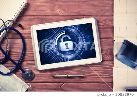 Web security and technology concept with tablet pc on wooden tab Web security and technology concept with tablet pc on wooden tab 30888970