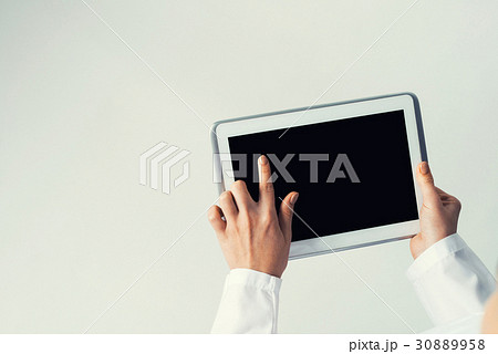 Close of female doctor hands working with tablet pc computer Close of female doctor hands working with tablet pc computer 30889958