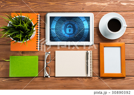Web security and technology concept with tablet pc on wooden table 30890392