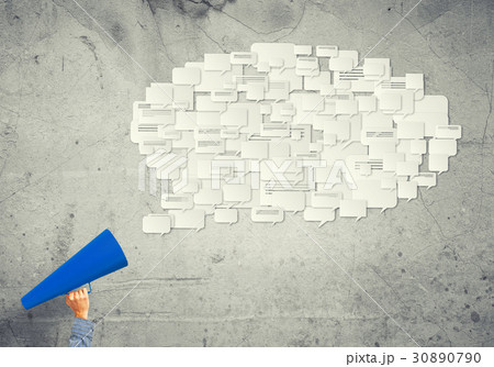 Hand of man holding red paper trumpet against concrete background 30890790