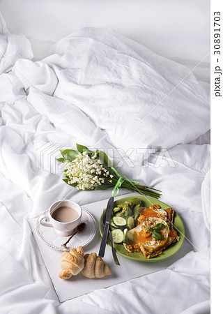 Fried eggs with toasts and tea in bed Fried eggs with toasts and tea in bed 30891703