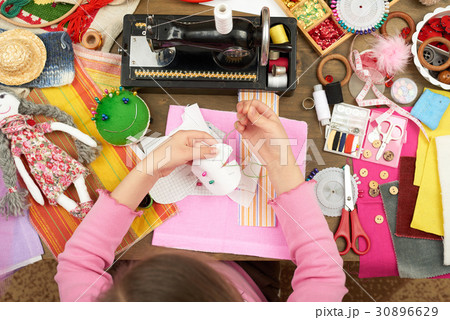 girl sews, top view, sewing accessories, handmade  30896629