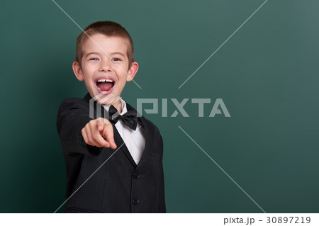 school boy near blank chalkboard background 30897219