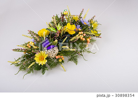 Composition made of artificial flowers, fruits, butterflies, birds and ears of wheat. Composition made of artificial flowers, fruits, butterflies, birds and ears of wheat. 30898354