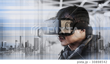 a guy wearing virtual reality googles 30898542