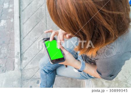 Beautiful girl holding a smartphone in the hands Beautiful girl holding a smartphone in the hands 30899345
