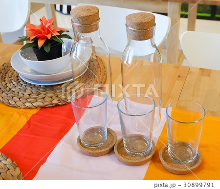Dishes with Glass and Glass Bottle on Table Dishes with Glass and Glass Bottle on Table 30899791