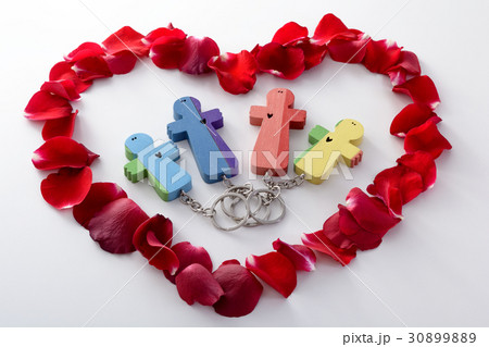 Wooden figures of family into heart from petals Wooden figures of family into heart from petals 30899889