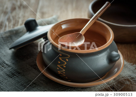 Clay pot for baking with lid with wooden spoon on Clay pot for baking with lid with wooden spoon on 30900513
