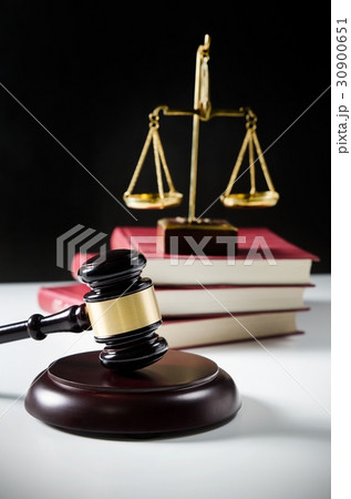 Wooden gavel and books on wooden table 30900651