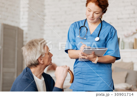 Neat mindful doctor hearing out her patient Neat mindful doctor hearing out her patient 30901714