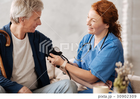 Diligent trained doctor putting on a blood Diligent trained doctor putting on a blood 30902309