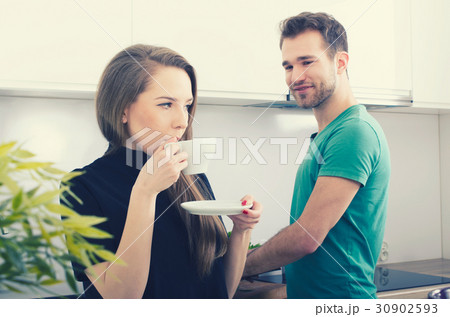Young couple spends time together in the kitchen Young couple spends time together in the kitchen 30902593