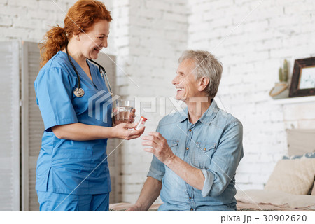 Competent positive lady helping elderly man Competent positive lady helping elderly man 30902620