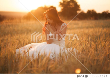Happy beautiful young bride outside on a summer Happy beautiful young bride outside on a summer 30903653