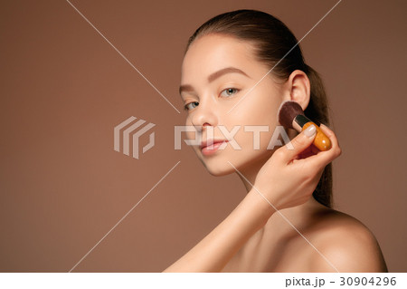 Beautiful female eyes with make-up and brush Beautiful female eyes with make-up and brush 30904296