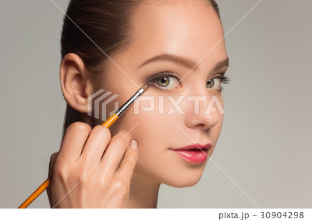 Beautiful female eyes with make-up and brush 30904298