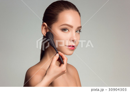 Beautiful female eyes with make-up and brush Beautiful female eyes with make-up and brush 30904303