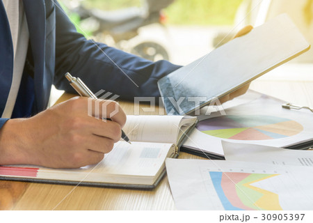 businessman writes business plan with tablet businessman writes business plan with tablet 30905397