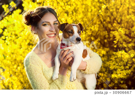 Beautiful woman playing with her dog. Outdoor 30906667