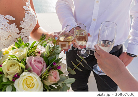 Flowers and wine glasses in the hands Flowers and wine glasses in the hands 30907036