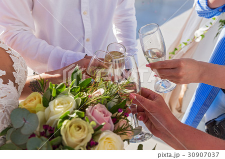 Flowers and wine glasses in the hands Flowers and wine glasses in the hands 30907037