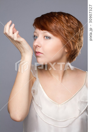 young woman smells pafrume on her hand young woman smells pafrume on her hand 30907327