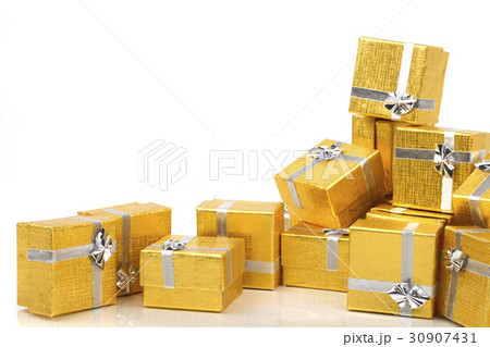A pile of gold gifts on white 30907431