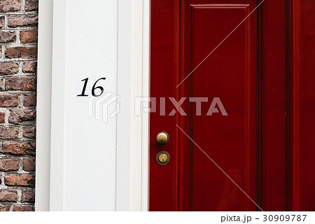 Classic red door with number 16. Vintage style 30909787
