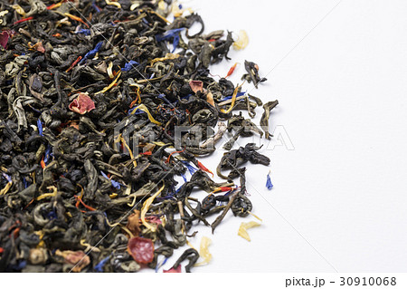 Closeup of heap of dry green tea leaves. 30910068