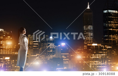 Woman looking at night city Woman looking at night city 30918088