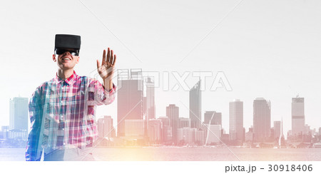 Guy wearing checked shirt and virtual mask stretching hand to touch something 30918406