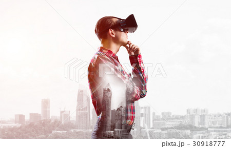 Guy wearing checked shirt and virtual mask with hand on chin Guy wearing checked shirt and virtual mask with hand on chin 30918777