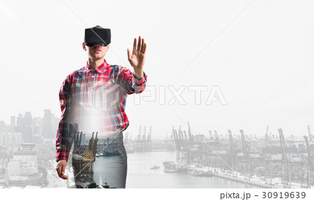 Guy wearing checked shirt and virtual mask stretching hand to touch something 30919639