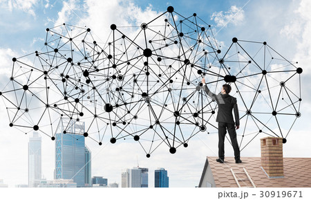 Businessman on house roof presenting networking and connection concept. Mixed media Businessman on house roof presenting networking and connection concept. Mixed media 30919671