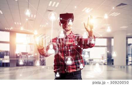 Guy wearing checked shirt and virtual mask reaching hand to touch screen Guy wearing checked shirt and virtual mask reaching hand to touch screen 30920050