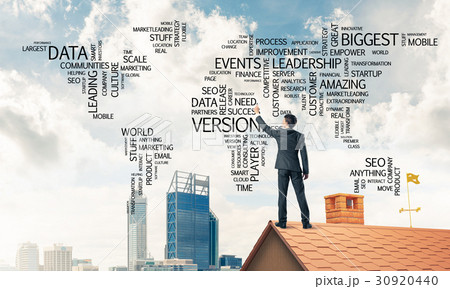 Businessman on brick roof draw world map as concept of globaliza Businessman on brick roof draw world map as concept of globaliza 30920440