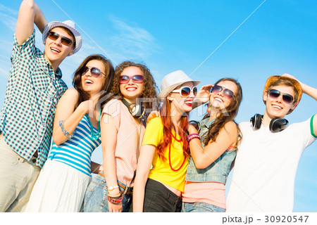 group of young people wearing sunglasses and hat group of young people wearing sunglasses and hat 30920547