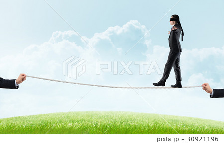 Business concept of risk support and assistance with man balancing on rope 30921196