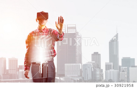 Guy wearing checked shirt and virtual mask stretching hand to touch something Guy wearing checked shirt and virtual mask stretching hand to touch something 30921958