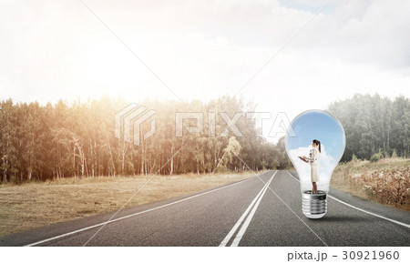 Businesswoman inside light bulb Businesswoman inside light bulb 30921960