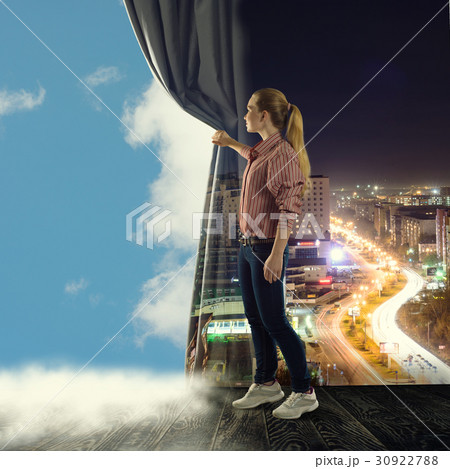 young woman pushes the curtain looking at clouds 30922788