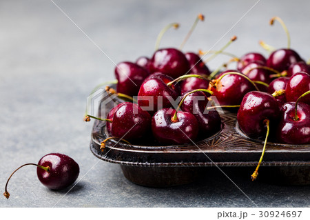 Black cherries in vintage dish. Stone background. Black cherries in vintage dish. Stone background. 30924697