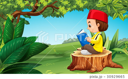 Muslim boy reading book in park 30929665
