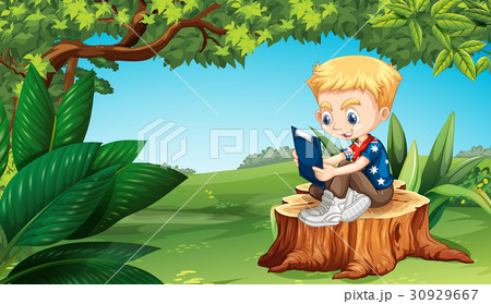 Boy reading in the park 30929667