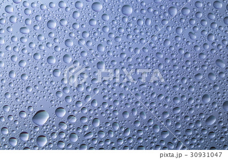 Closeup of water drops on glass surface Closeup of water drops on glass surface 30931047