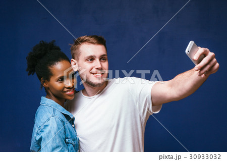 White man and black woman make selfie, fun and joy White man and black woman make selfie, fun and joy 30933032