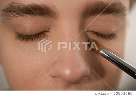 Applying concealer on man to cover dark circles Applying concealer on man to cover dark circles 30933566
